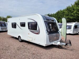 White caravan with black and red accents, ideal for touring and holiday trips.