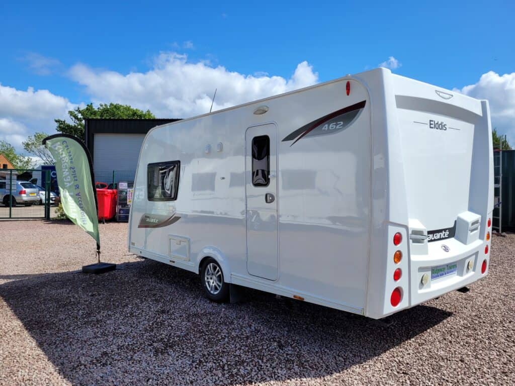 Modern white Elddis caravan parked outdoors on a sunny day.