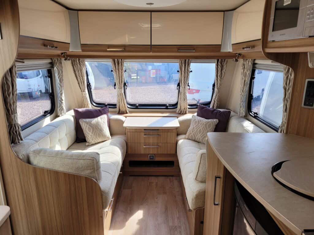 Comfortable caravan interior with cozy seating and large windows, perfect for relaxing holidays and.