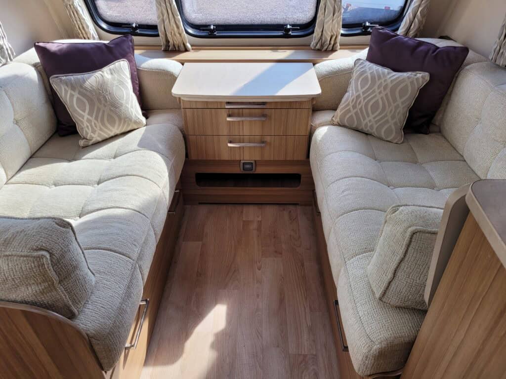 Relaxing caravan interior with cozy seating area and stylish cushions.