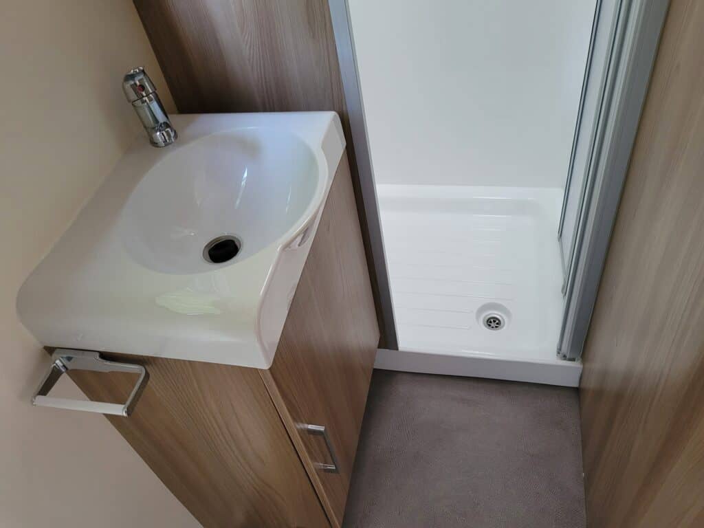 Compact bathroom sink and shower at Ridgeway Tourers.