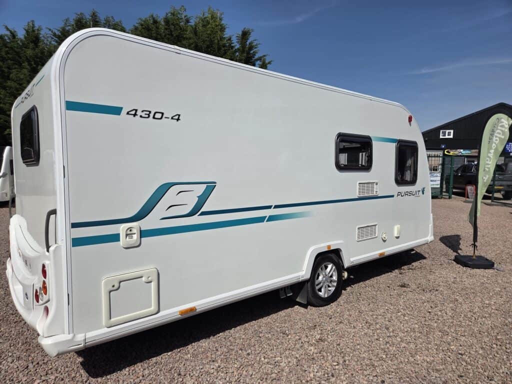 Modern white caravan with blue accents at Ridgeway Tourers site.